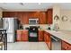 Kitchen featuring stainless steel appliances, wooden cabinets and quartz countertops at 5076 Tideview Cir # 90, Orlando, FL 32819
