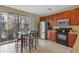 Kitchen featuring stainless steel appliances, wooden cabinets and a glass dining table at 5076 Tideview Cir # 90, Orlando, FL 32819