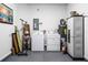 Functional laundry room with a white washer and dryer, water heater, utility closet, and wall-mounted electric panel at 5076 Tideview Cir # 90, Orlando, FL 32819