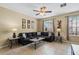 Cozy living room features a ceiling fan, large windows, and comfortable seating for relaxing and entertaining at 5076 Tideview Cir # 90, Orlando, FL 32819
