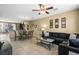 Open-concept living room and dining area with neutral tones, tile floors, and comfortable seating at 5076 Tideview Cir # 90, Orlando, FL 32819