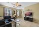Comfortable living room with tile flooring, ceiling fan, and large windows for ample natural light at 5076 Tideview Cir # 90, Orlando, FL 32819