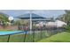 Community playground featuring basketball court, slides and other play equipment surrounded by fencing at 513 Seasons Ct, Winter Springs, FL 32708