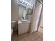 Bathroom featuring white vanity with gold accents, sink with modern fixtures, and a mirrored wall cabinet at 513 Seasons Ct, Winter Springs, FL 32708