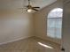 Bedroom featuring tile flooring, a ceiling fan with light, and a large arched window at 513 Seasons Ct, Winter Springs, FL 32708