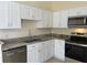 Updated kitchen boasts stainless steel appliances, sleek countertops, and bright white cabinetry at 513 Seasons Ct, Winter Springs, FL 32708