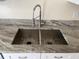Modern stainless steel kitchen sink with updated faucet and beautiful countertops at 513 Seasons Ct, Winter Springs, FL 32708