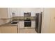 Renovated kitchen with granite countertops, stainless steel appliances, and white cabinetry at 513 Seasons Ct, Winter Springs, FL 32708
