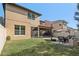 Exterior view of the backyard with a covered patio and a stone fire pit at 583 Treehouse St, Winter Springs, FL 32708