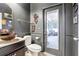 Bathroom with dark gray walls, vessel sink, decorative accents, and access to a screened lanai at 583 Treehouse St, Winter Springs, FL 32708