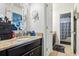 Bathroom with granite countertops, decorative mirror and vanity with drawers at 583 Treehouse St, Winter Springs, FL 32708