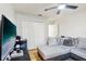 Cozy bedroom featuring a gray sectional sofa, ceiling fan, closet, and wood-look floors at 583 Treehouse St, Winter Springs, FL 32708