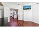Bedroom with hardwood floors, TV, and an open doorway to the kitchen with a granite island at 583 Treehouse St, Winter Springs, FL 32708