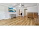 Spacious bedroom featuring hardwood floors, two dressers, and a mounted TV at 583 Treehouse St, Winter Springs, FL 32708