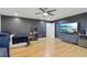 Bedroom featuring a large TV, arcade game and hardwood floors at 583 Treehouse St, Winter Springs, FL 32708