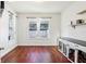 Bright room with hardwood floors, large windows, white curtains and a modern dog kennel at 583 Treehouse St, Winter Springs, FL 32708