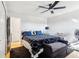 Bedroom with ceiling fan, wood-look floors, and a large bed with decorative pillows at 583 Treehouse St, Winter Springs, FL 32708