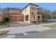Charming two-story home featuring a red tile roof, arched entryway and attached two-car garage at 583 Treehouse St, Winter Springs, FL 32708
