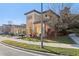 An exterior view of a well-maintained home featuring an arched entryway and landscaped garden at 583 Treehouse St, Winter Springs, FL 32708