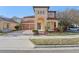 Charming two-story home featuring a tiled roof, arched entryway, and beautiful landscaping at 583 Treehouse St, Winter Springs, FL 32708