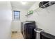Laundry room with a modern washer and dryer, wire shelf, and tiled floors at 583 Treehouse St, Winter Springs, FL 32708