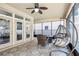 Spacious covered patio with tile flooring, seating, and an egg chair at 583 Treehouse St, Winter Springs, FL 32708