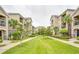 Well-maintained apartment complex featuring manicured lawns and tropical landscaping at 6524 Swissco Dr # 1033, Orlando, FL 32822