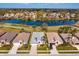 Aerial view of property outlining house, showcasing nearby lake, golf course and neighborhood at 8011 Saint James Way, Mount Dora, FL 32757