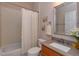 Bright bathroom features a shower-tub combo, granite-topped vanity, framed mirror and decorative accents at 8011 Saint James Way, Mount Dora, FL 32757