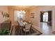 Cozy dining room features elegant chandelier, modern furniture, and serene ambiance at 8011 Saint James Way, Mount Dora, FL 32757