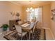 Well-lit dining room showcases modern chandelier, stylish table and chairs, and adjacent cabinet at 8011 Saint James Way, Mount Dora, FL 32757