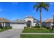 Charming single-story home featuring a two-car garage, well-manicured lawn and lovely landscaping at 8011 Saint James Way, Mount Dora, FL 32757