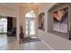 Inviting foyer with decorative art niches, stylish lighting, tiled flooring, and decorative glass entry door at 8011 Saint James Way, Mount Dora, FL 32757