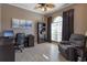 Functional home office with a desk, bookshelf, and comfortable seating area at 8011 Saint James Way, Mount Dora, FL 32757