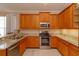 Modern kitchen with granite countertops, stainless steel appliances and ample cabinet space at 8011 Saint James Way, Mount Dora, FL 32757