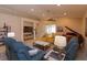Cozy living room featuring comfortable seating, entertainment center, and piano at 8011 Saint James Way, Mount Dora, FL 32757