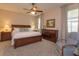 Comfortable main bedroom with a ceiling fan, dresser, and sitting chair at 8011 Saint James Way, Mount Dora, FL 32757