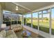 Inviting screened-in patio featuring comfortable seating and views of the well-maintained landscaping at 8011 Saint James Way, Mount Dora, FL 32757