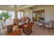 Bright sunroom with wicker furniture, tile flooring, and lots of natural light at 8011 Saint James Way, Mount Dora, FL 32757