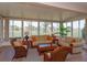 Relaxing sunroom with comfortable seating, scenic views, and plenty of natural light at 8011 Saint James Way, Mount Dora, FL 32757