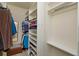 Organized walk-in closet featuring built-in shelving and hanging rods for storage at 8011 Saint James Way, Mount Dora, FL 32757