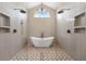 Luxurious bathroom featuring a standalone tub, dual shower heads, and modern fixtures at 9333 Bay Vista Estates Blvd, Orlando, FL 32836