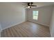 An airy, bright bedroom featuring wood-look floors, natural light, and a ceiling fan at 9333 Bay Vista Estates Blvd, Orlando, FL 32836