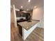 Modern kitchen featuring stainless steel appliances and an island with granite countertops at 9436 Westside Hills Dr, Davenport, FL 33896