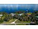 Stunning aerial view showcasing waterfront homes with private docks surrounded by lush trees on a sunny day at 9575 Ne 306Th Ct, Fort Mc Coy, FL 32134