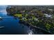 Aerial view of a sprawling waterfront property with lush greenery, including a pool and private dock, offering serene living at 9575 Ne 306Th Ct, Fort Mc Coy, FL 32134