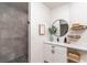 Modern bathroom with a glass-enclosed shower and a stylish vanity with a round mirror at 9575 Ne 306Th Ct, Fort Mc Coy, FL 32134