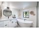 Modern bathroom featuring white cabinets, a soaking tub and a walk-in shower at 9575 Ne 306Th Ct, Fort Mc Coy, FL 32134