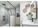 Modern bathroom featuring a glass-enclosed shower with sleek black fixtures and stylish decor at 9575 Ne 306Th Ct, Fort Mc Coy, FL 32134