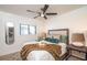 Cozy bedroom with a comfortable bed, stylish lamps, and a view through the window at 9575 Ne 306Th Ct, Fort Mc Coy, FL 32134